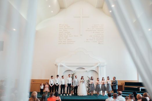 SACRAMENTO, USA - MAY 12 th 2018: The bride and groom get married and receive a blessing in the church building in the presence of guests