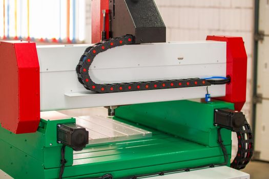 Dynamic part of automated CNC equipment for working with metal. The programmed robot head. Telephoto shot