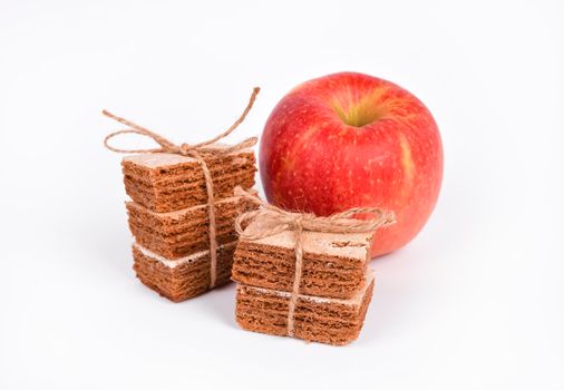 Apple pastila and red apple isolated on white background. Healthy snack concept. Slices of pastila tied with a twine