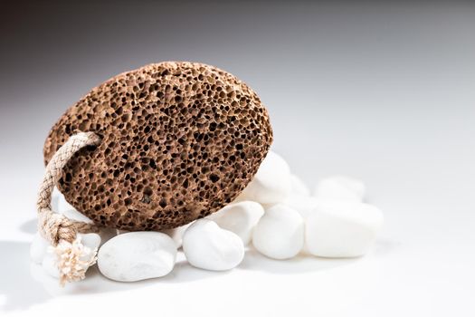 Brown pumice stone for home spa over white background