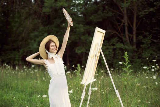 cheerful woman outdoors drawing art landscape hobby. High quality photo