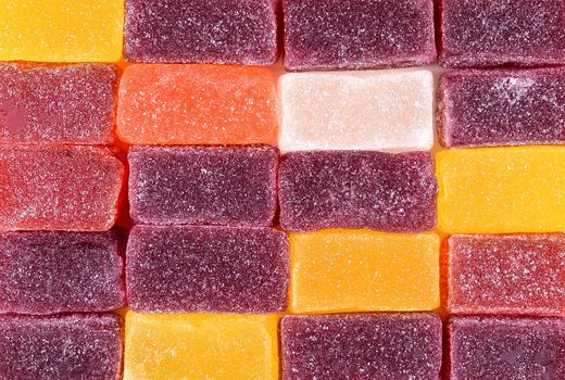 Marmalade sweets background. Gelly candies close up. Colorful swets. Jelly cubes sprinkled with sugar