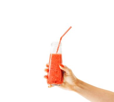 Female hand holding bottle of berry smoothie healthy drink on a white background.