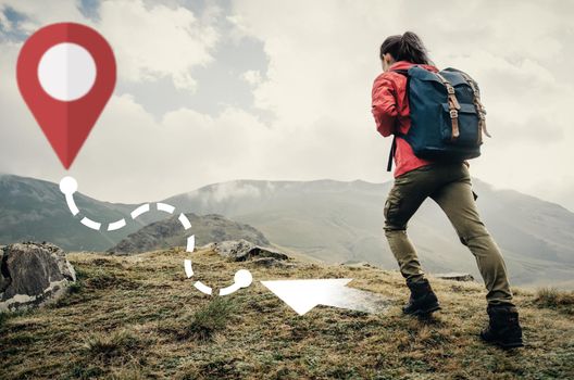 Hiker backpacker young woman going up on mountain to route with location GPS pin outdoor. Navigation concept.