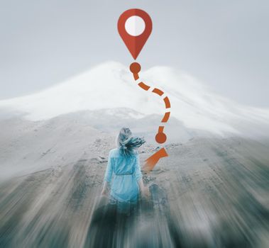 Rear view of dreaming young woman in front of mount Elbrus outdoor and GPS route to peak. Navigation concept. Image with moving fast and motion blur effect.