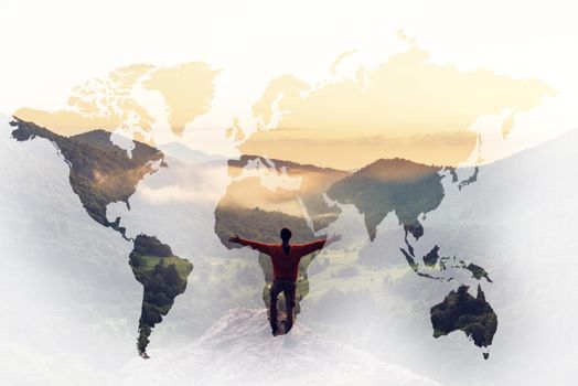 Double exposure of traveler young man with raised arms in summer mountains at sunset with map of world. Concept of journey and wanderlust.