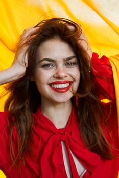 cheerful woman in red dress makeup yellow cloth posing. High quality photo