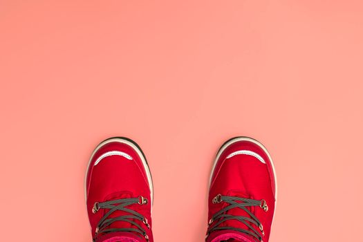 Kids or teenage pink winter boots isolated on pink background. Winter boots for girls. Top view banner.