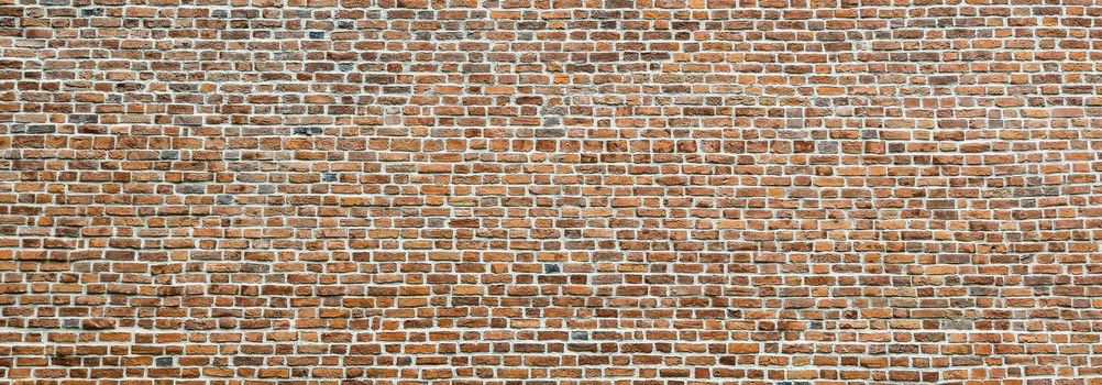Brick wall, wide panorama of masonry. Wall with small Bricks. Modern wallpaper design for web or graphic art projects. Abstract template or mock up.