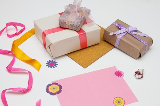 pink card paper and beautiful gifts on a white background Thanksgiving, birthday, mother's day, copy space,paper flowers,ribbon and bows decor