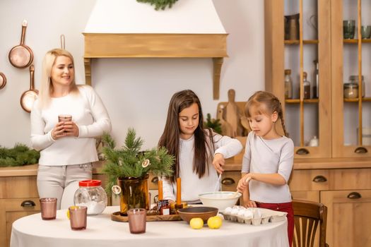 happy sisters children girls two little girls cooking before christmas in the kitchen