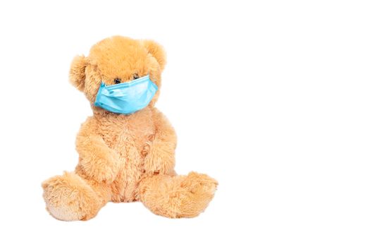 Teddy bear wear PP non-woven disposable medical face mask isolated on white background. Stop Coronavirus and Air pollution concept. Copy space