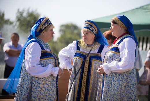 20 August 2018, Krasnovidovo, Russia - mature women in blue folk costume
