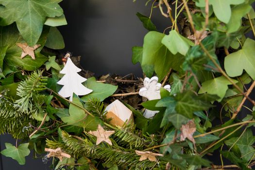 Front door with a Christmas wreath of ivy and bows.