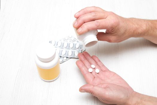 male hand pills tablets in the palm