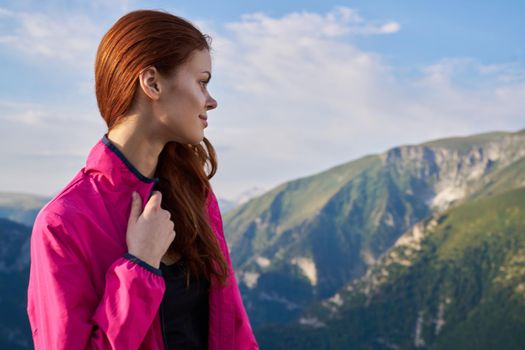 woman hiker outdoors in the mountains landscape fresh air. High quality photo