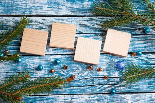 wooden squares for your date new year top view blue background spruce branch top view place copy