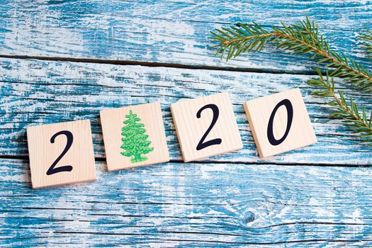 wooden squares with the inscription 2020 date. new year, holiday background, copy place, top view, square
