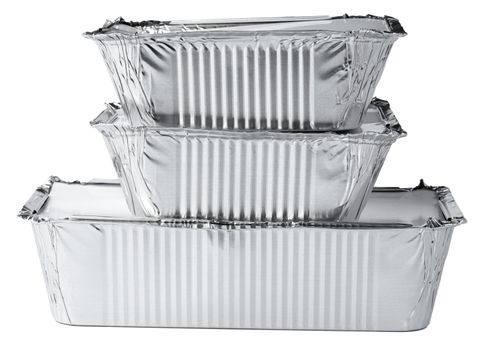 Packed foil food boxes on white background, copy space, close up