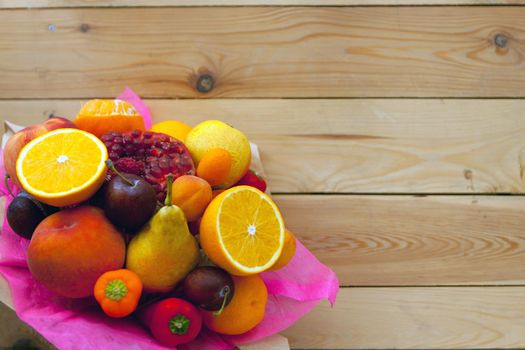 fruit fresh bouquet on wooden table flat lay- thanksgiving day, healthy eco food, selective focus. Autumn harvest concept, old wooden table with oranges, plums, peppers, pear and peaches