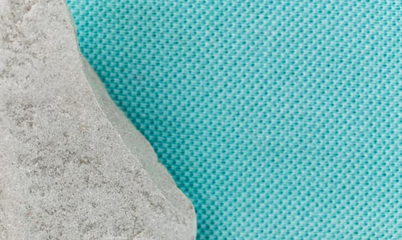 Gray stone fabric background of trendy aqua blue with empty place for text.
