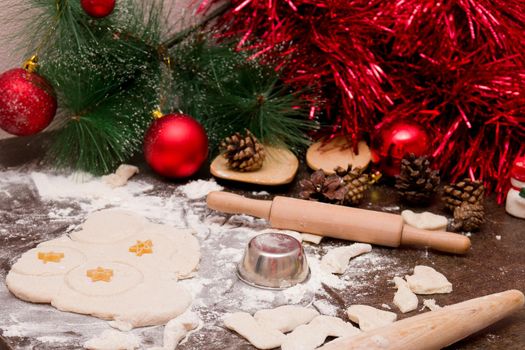 making christmas cookies, wooden kitchen utensils, red christmas decorations, batter for baking, cookie mold