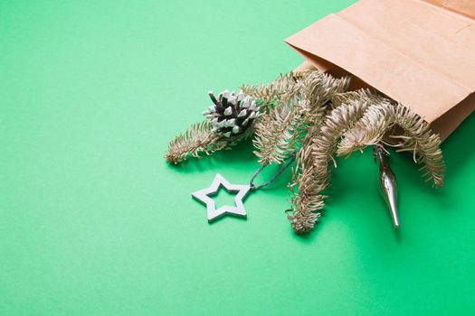 bouquet decorated with pine cones and Christmas toys, green background copy space