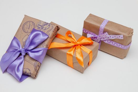 packed in brown gifts with bright ribbons and bows on a white background, mother's day, thanksgiving, presents