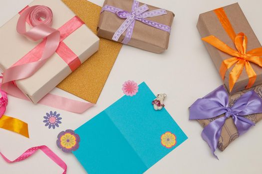 blue card paper and beautiful gifts on a fucking background Thanksgiving, birthday, mother's day, copy space,paper flowers,ribbon and bows decor