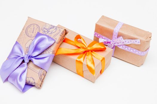 packed in brown gifts with bright ribbons and bows on a white background, mother's day, thanksgiving, presents