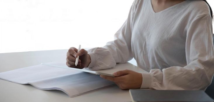 Young asian business working with financial papers and smart laptop in the modern office