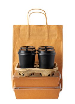 Craft paper bag and coffee to go cups on white background close up