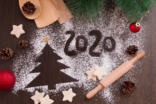tree, new year 2020, numbers on flour, dark brown background, christmas background, new year, christmas, preparing cookies for the holiday, copy place, top view, cones, christmas toys, pine branch