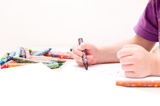 child draws a house on a white background