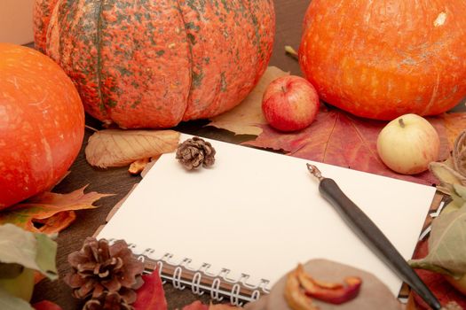 autumn fruits and vegetables on a dark background with a notebook, copy space, theme of health and seasonal colds