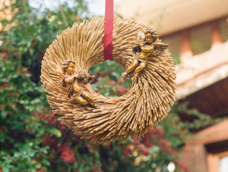 Golden angels on a straw wreath for Valentin's day or Christmas