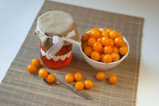 cherry plums yellow Jam, fresh vitamins-berries fruits. homemade marmalade in glass jar on brown background