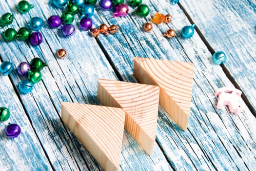 tree made of wooden triangles on blue plank background