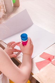 the child makes an applique, crafts from colored paper and toilet paper stools, what to do with the child at home, development of imagination and fine motor skills of hands