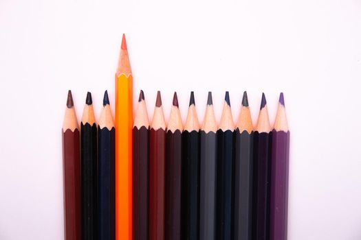 color pencils on a white background isolated texture top view copy space brown black grey blue violet uniqueness abstract
