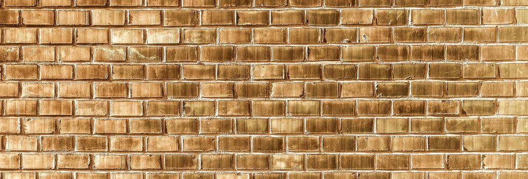 Golden Brick wall texture close up. Top view. Modern brick wall wallpaper design for web or graphic art projects. Abstract background for business cards and covers. Template or mock up.