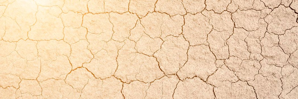 Texture of very dry and cracked earth. Drought or lack of water concept. Long banner with copy space and overexposed effect
