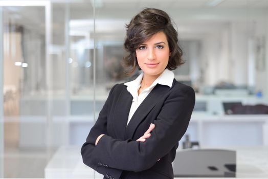 Portrait of a business woman in an office. Crossed arms