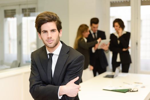 Image of business leader looking at camera in working environment