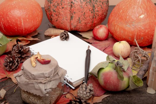 copybook tea can, autumn fruits and vegetables on a brown wooden table, dry fruits, apples, pumpkins, autumn mood, healthy, copy space, cones and branches, autumn composition, orange, red, yellow, cozy still life,white sheet for text