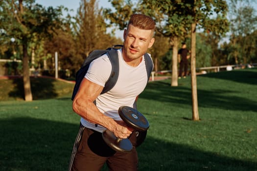 sportive man workout in the park morning motivation. High quality photo