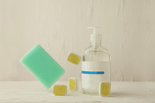 washing tablets and liquid in levitation. Dishwasher tabs for cleaning with cponge