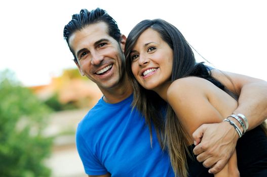 Closeup portrait of a beautiful young couple smiling together