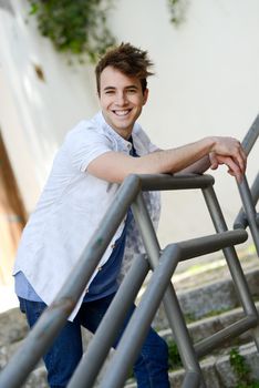 Portrait of attractive young man smiling in urban background