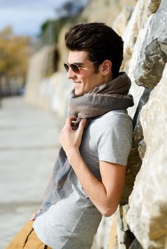 Portrait of a young handsome man, model of fashion, with sunglasses